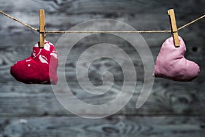 Two pink hearts apart on wooden background