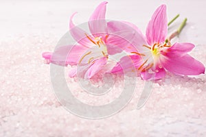 Two pink lilies and mineral bath salts. Selective focus. Pink Rain Lily