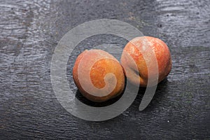 Two pink peach fruits isolated on black background, fresh Peach on black background