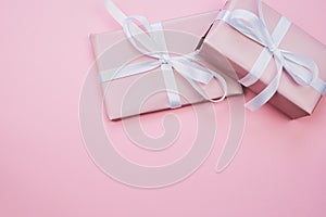 Two pink presents on pink background with copy space photo
