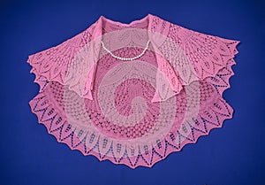 Two pink shawls on blue background