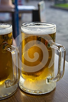 Two pint glasses with cold beer served outdoor