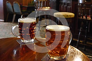 Two pints of beer in a typically traditional British pub photo