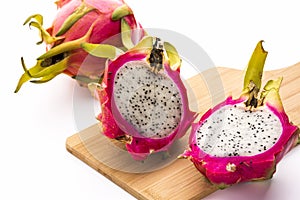Two Pitaya Halves And A Whole Dragonfruit photo