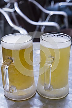 Two pitchers fresh of beer