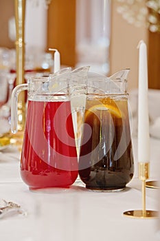 Two pitchers of refreshing drinks on the table at the ceremony. Selective focus. Close-up