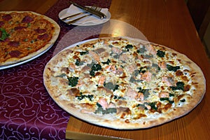 Two pizza on a plate in restaurant
