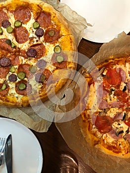 Two pizzas are on the table vertical photo. selectiv focus