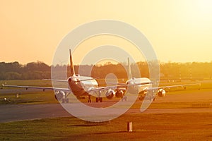 Two planes line up, sunset
