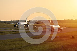 Two planes line up, sunset