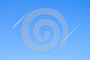 Two planes in the sky flying synchronously