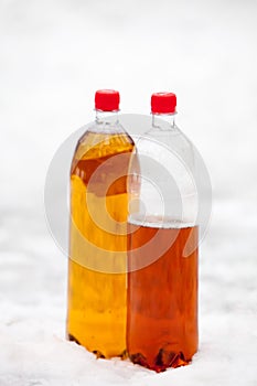 Two plastic beer one litre bottles full and half with red caps o photo