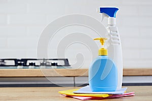 Two plastic bottle on wooden table with color cloths on kitchen background