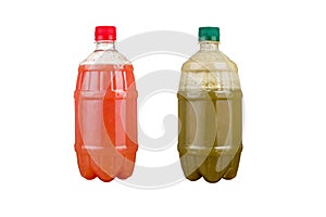 Two plastic bottles with colorful natural juices. Isolated