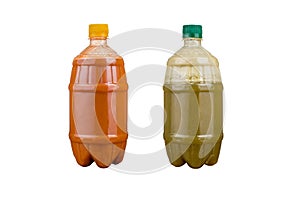 Two plastic bottles with colorful natural juices. Isolated