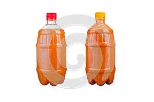 Two plastic bottles with colorful natural juices. Isolated