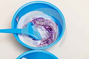 Two plastic bowls with bleach hair dye