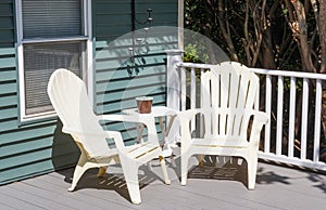 Two plastic chairs in the cornor of a new composite deck
