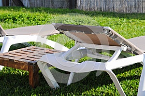 Two plastic hammocks and wooden table on backyard