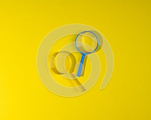 Two plastic magnifiers on a yellow background