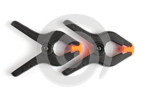 Two plastic studio clamps on a white background, close-up
