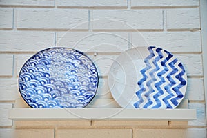 Two plates with blue patterns as an interior decoration.