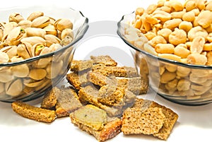 Two plates with tasty nuts and crackers photo