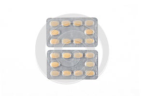 Two plates of yellow tablets on white isolated background