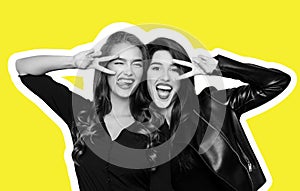 Two playful girls gesturing v-sign near eyes on yellow