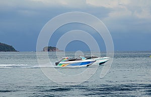 Two pleasure boats racing one another in tropical bay