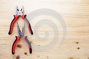 Two pliers on a wood table