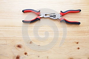 Two pliers on a wood table