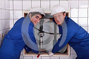 Two plumbers resting after work