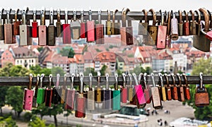 Two poles with love locks, in the background houses of Erfurt, Germany photo