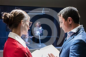 Two police detectives analyzing the files of a criminal case photo