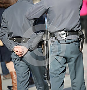 two policemen on patrol with handcuffs and buggy during the patr