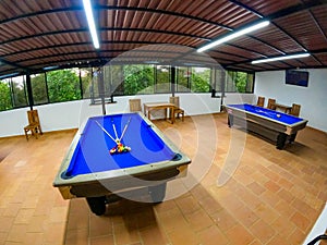 two pool tables ready to play in blue color