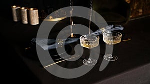 Two popular vintage champagne glasses on a dark background of the served table