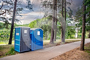Two portable toilets in a park