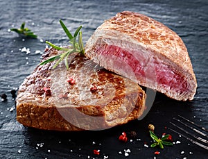 Two portions of lean trimmed grilled beef steak photo