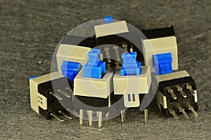 Two-position microswitches commutators with mechanical latching