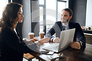 Two positive employees communicating while having a rest