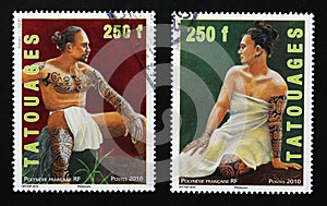 Two nice portraits of tattoed polinesian people on stamps