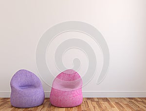 Two poufs near empty wall.