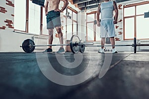 Two Powerful Guys In Gym Are Lifting Barbells