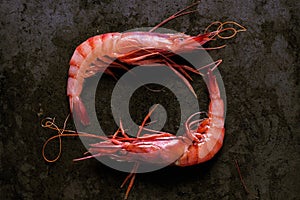 Two prawns on a black stone