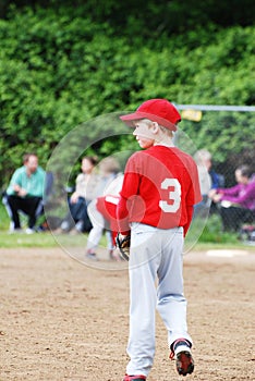 Two pre-teen baseball players discussing the game