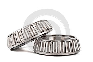 Two precision metal bearings on a white background