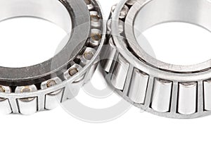 Two precision metal bearings on a white background. Close up