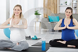 two pregnant women doing stretching
